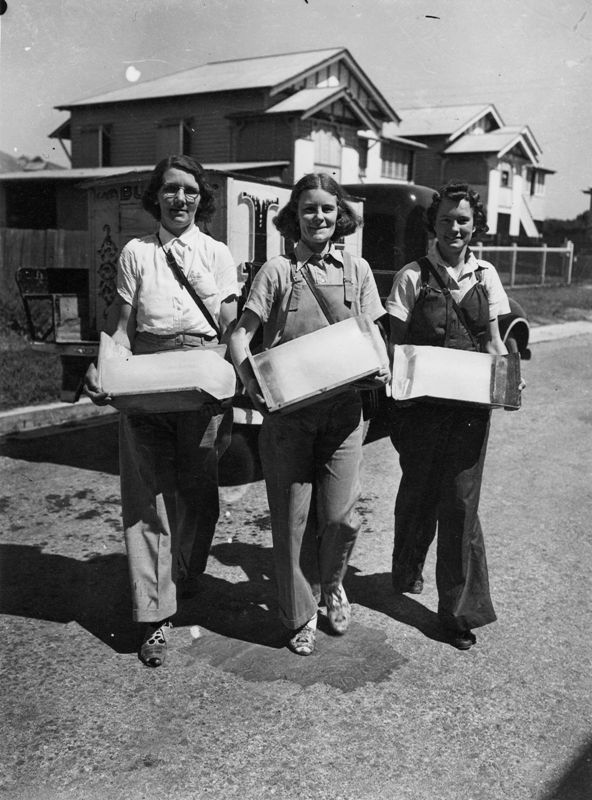 3 women selling ice in the suburbs, Brisbane, 1942, standing in front of cart and house.