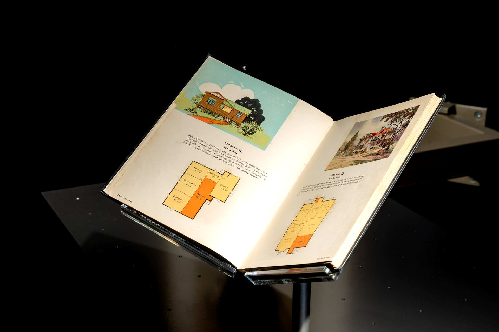 Open book showing house designs. 