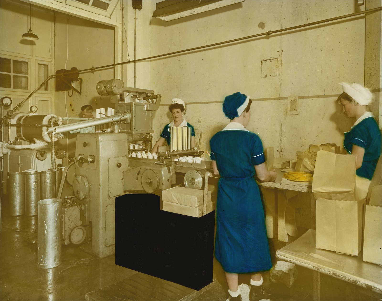 Three women working on the production line at Peters Arctic Delicacy Company factory in West End, Brisbane. 