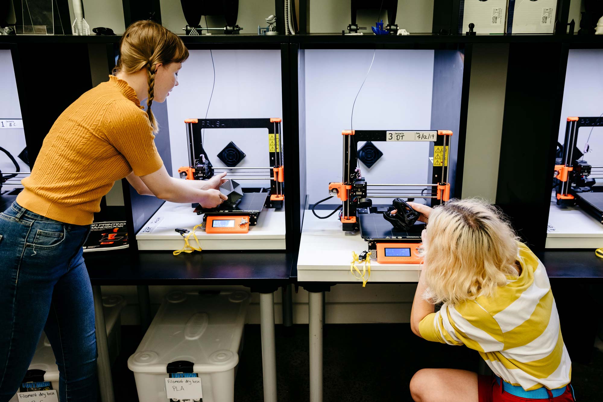 Two people using 3D printers in the Edge