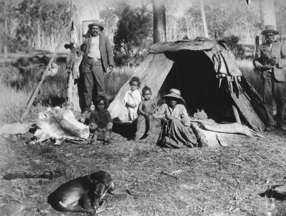 Group of Aboriginal men, women and children with animal skins in Ipswich.