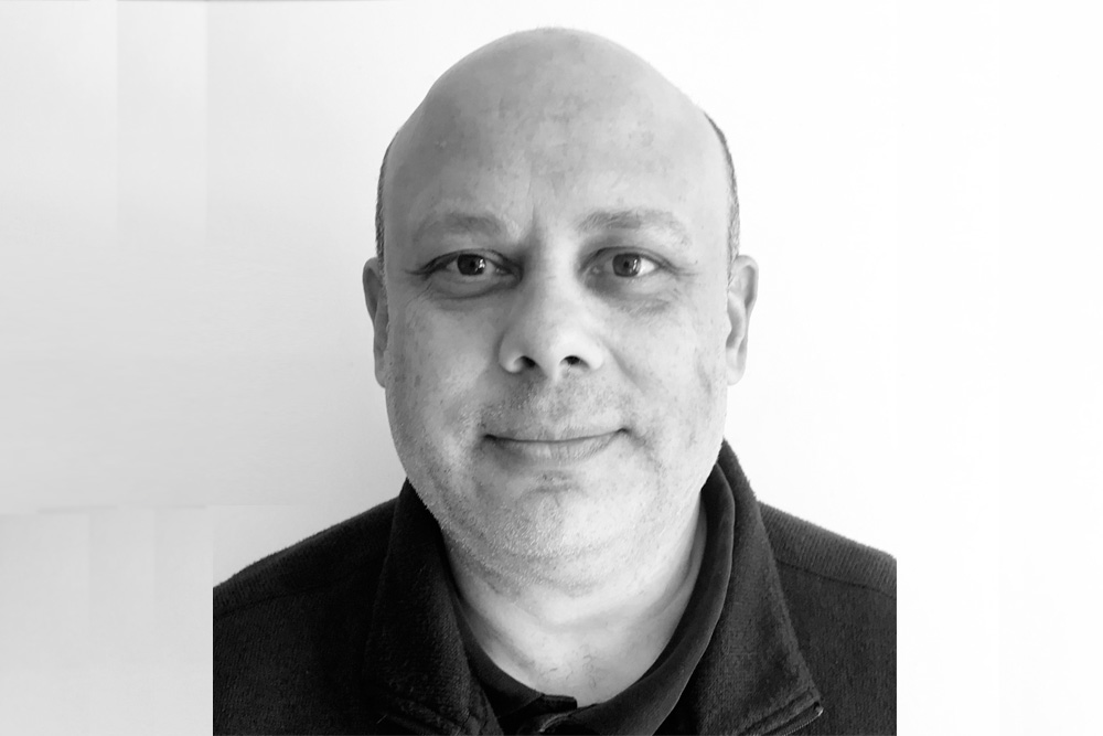 Black and white photo of a man wearing a dark jumper