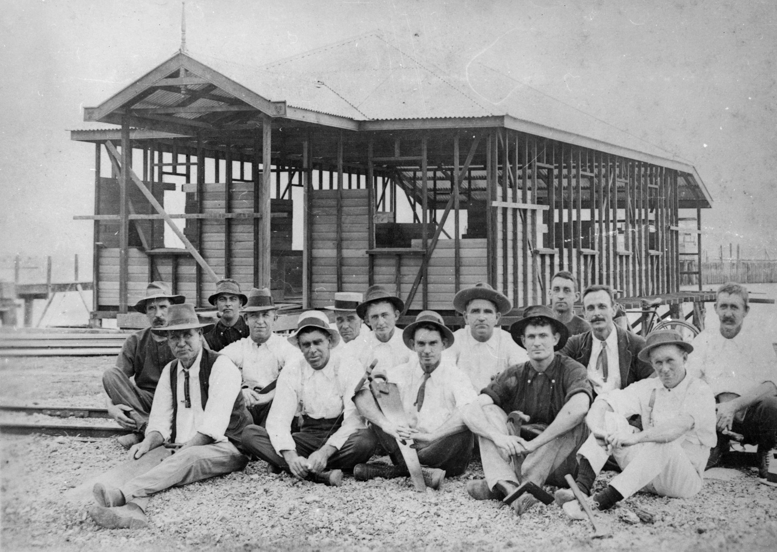 A group of men out the front of a house they are building