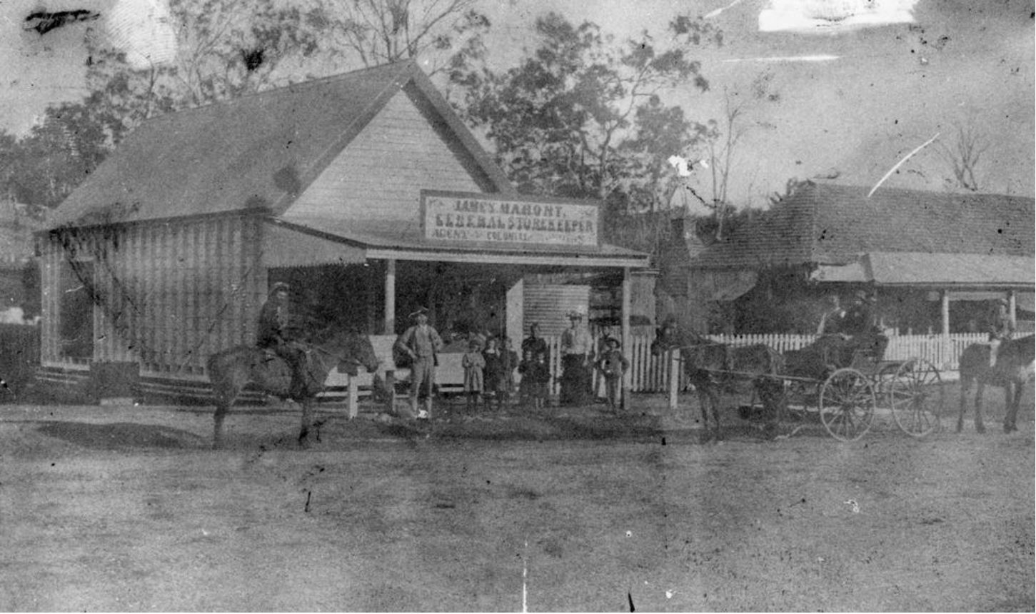 Old black and white photo of James Mahoney Store Leyburn in 1895 with seven people standing outside and one man on a horse