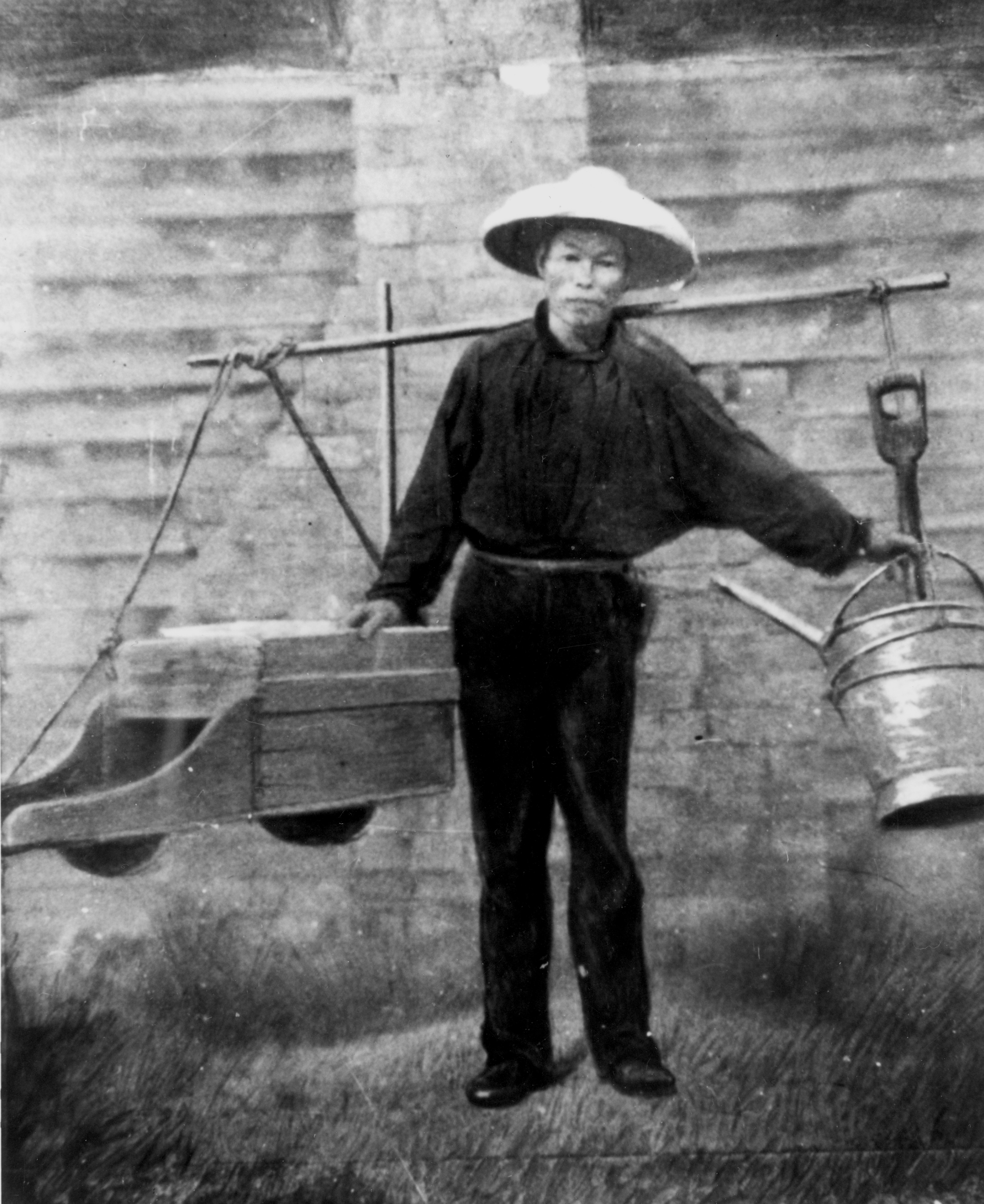 Chinese gold digger, with his mining tools suspended from a yoke across his shoulders, starting for work in the 1860s.
