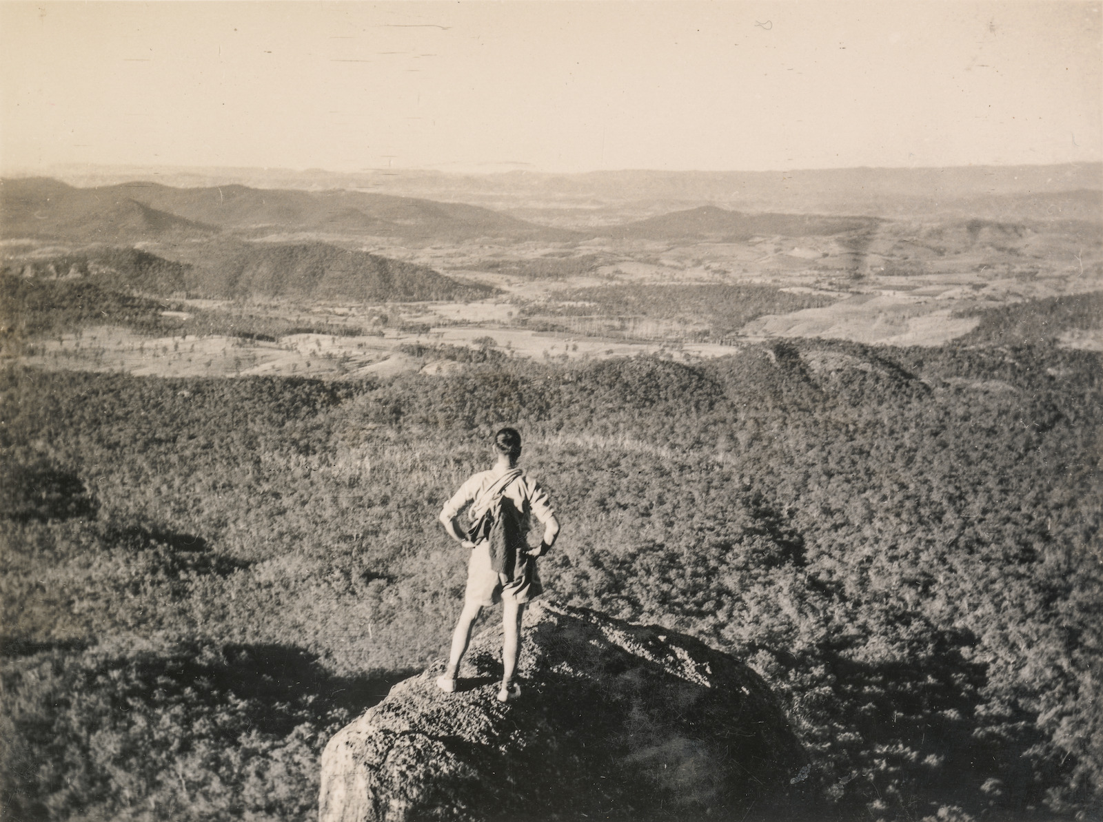 Bushwalker standing on a rock looking towards Mount Gillies near Mount Barney in 1941.