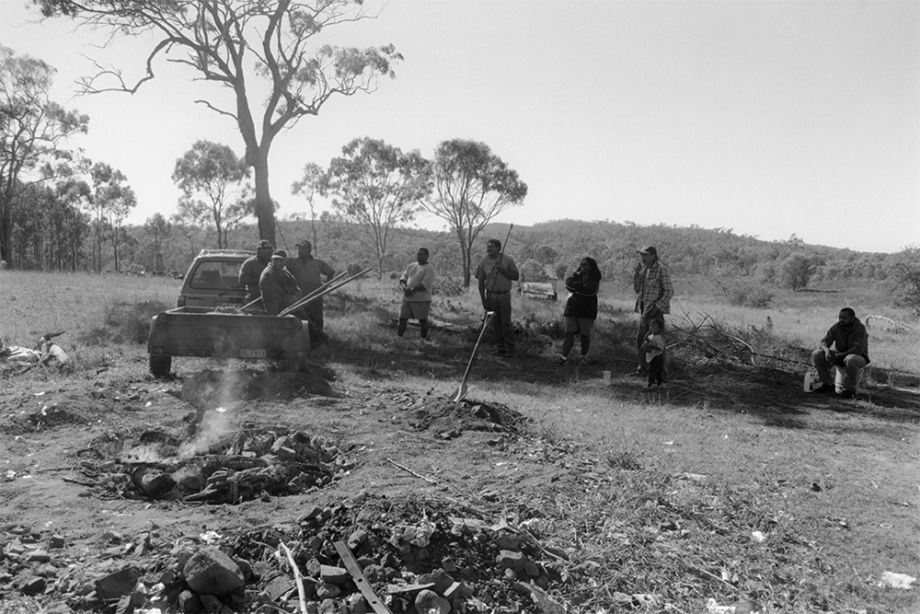 Group of Australian South Sea Islander men watching the hungi pit in Lakes Creek, Rockhampton, Queensland