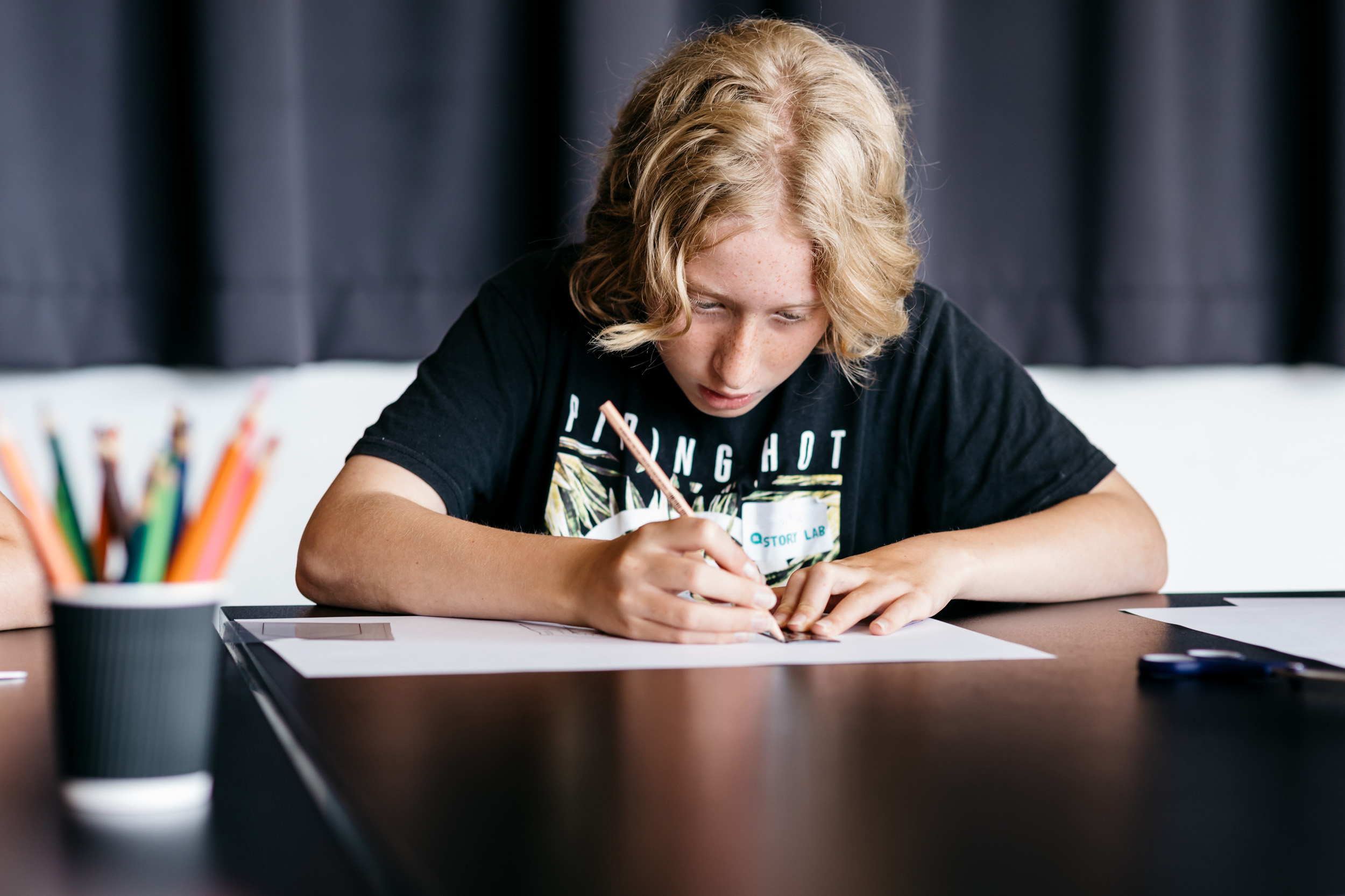 Teenager creating a book