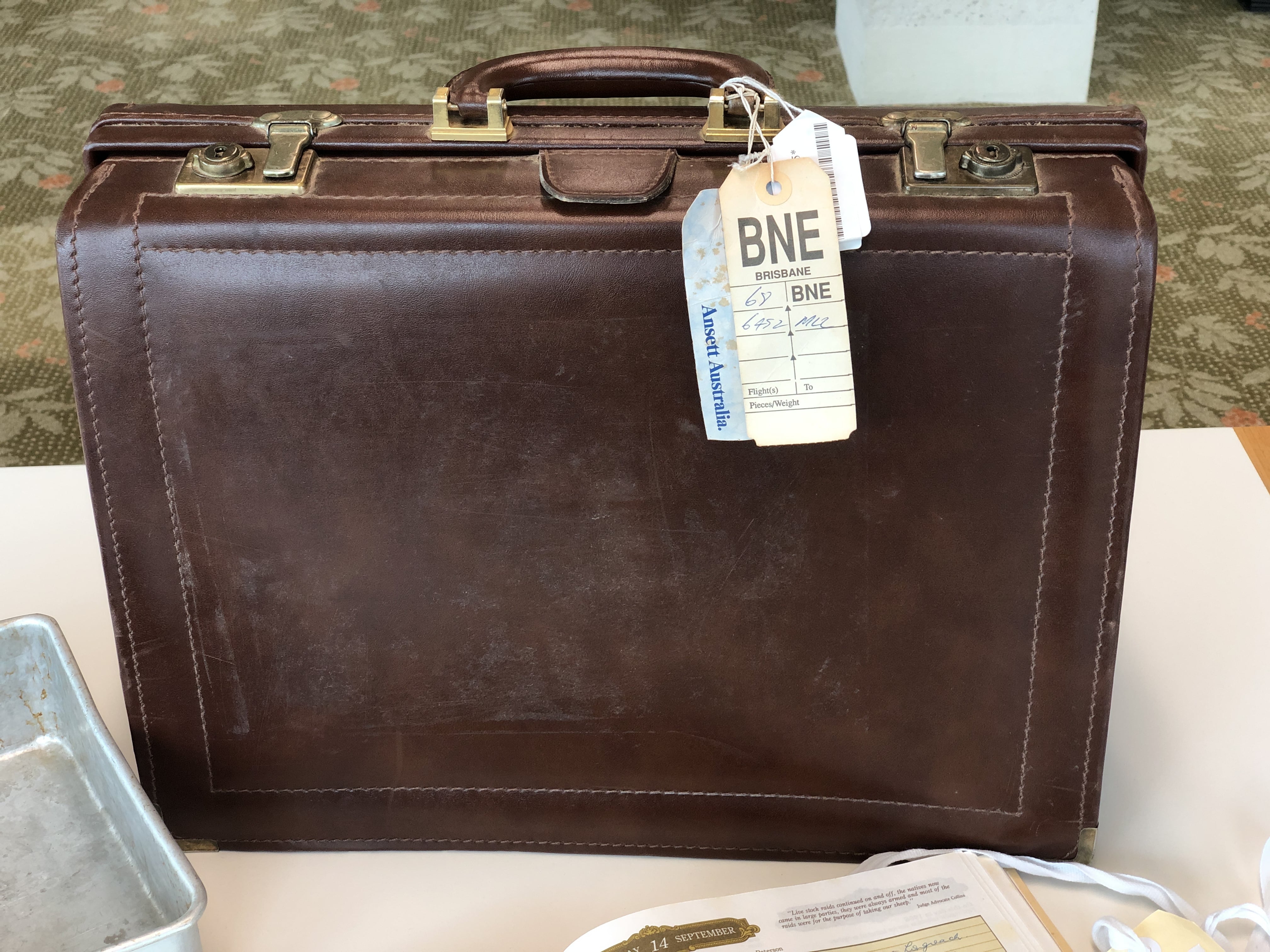 Leather briefcase used by Sir Joh that still contains an original luggage label.