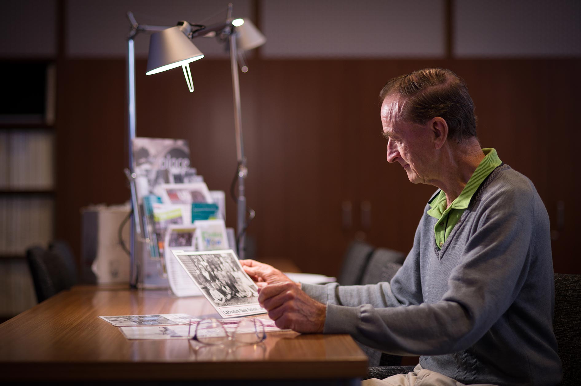 Man looking at photograph at the Caboolture public library
