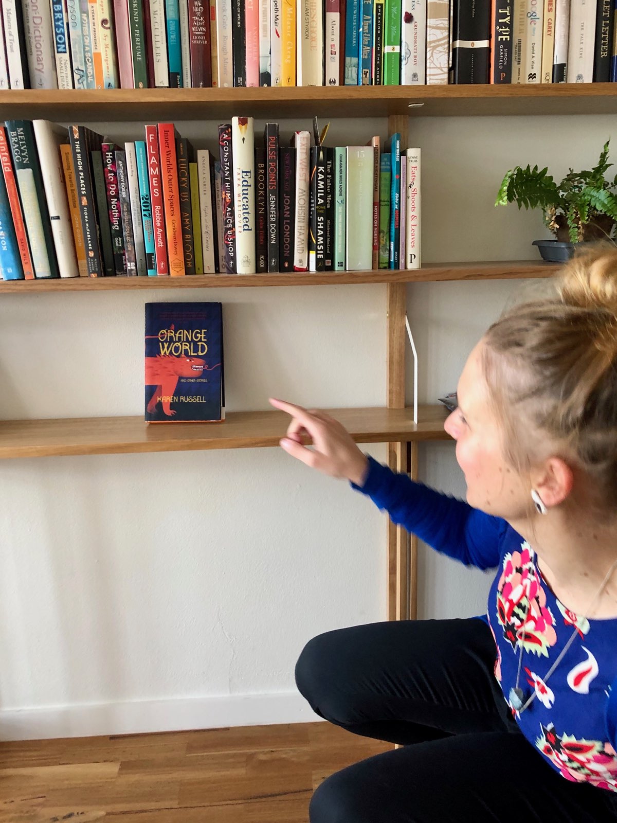 Laura Elvery pointing at Karen Russell's book Orange World