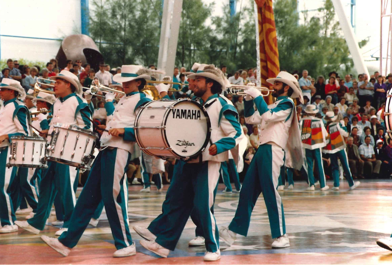 A color photograph of the Expo City Marching band performing in the Expo 88 Piazza