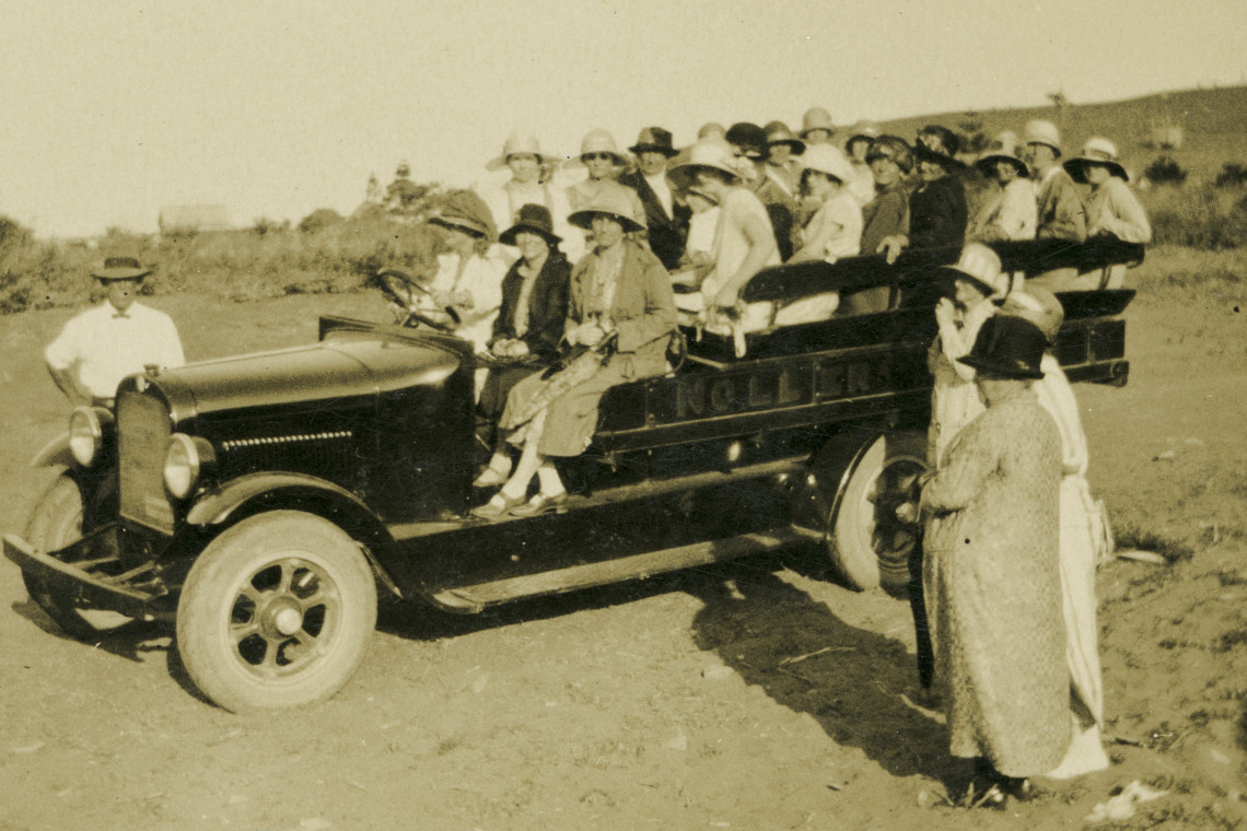 A black of white photogroph of a group of women in a car.
