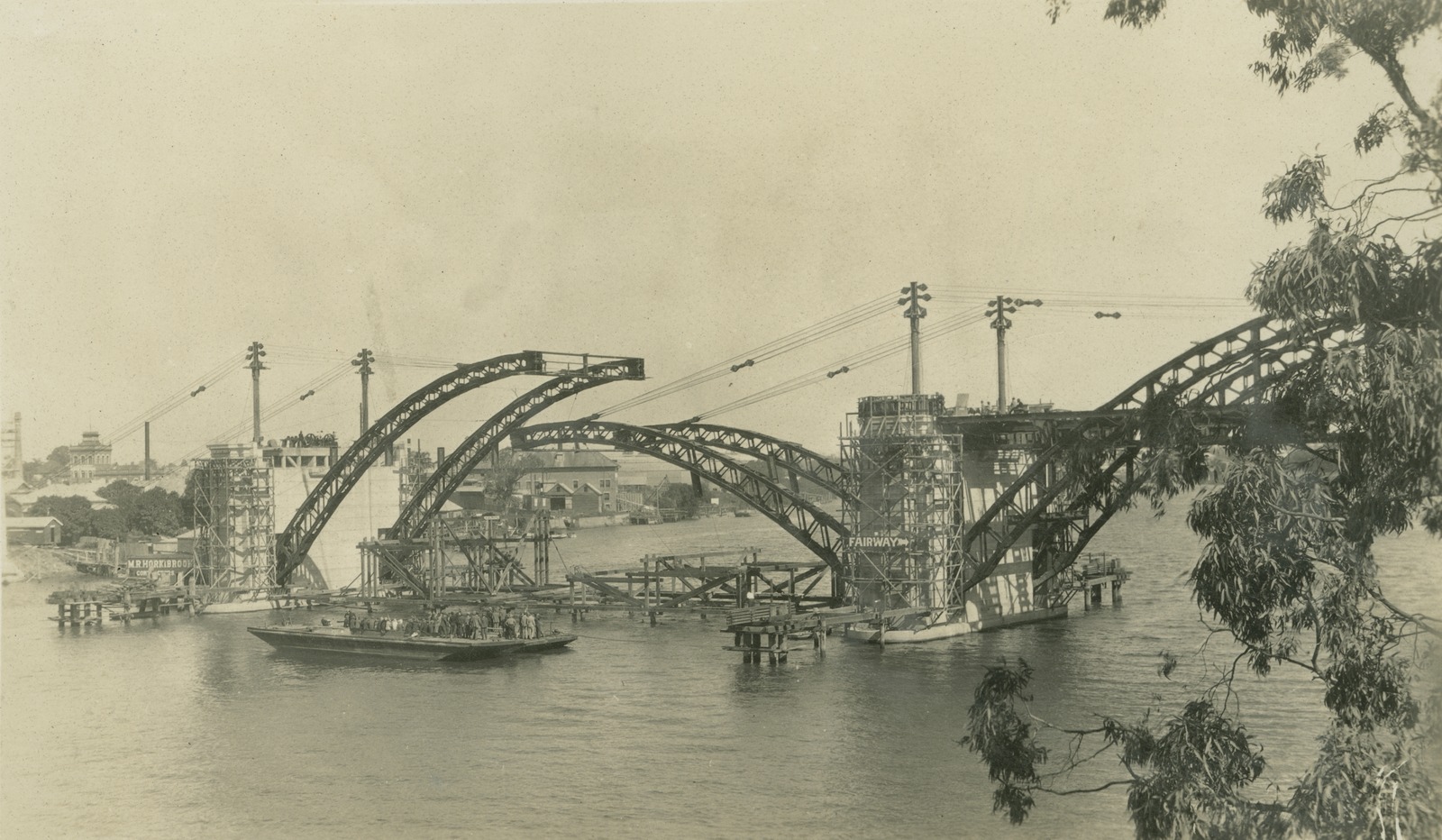 William Jolly Bridge under construction, with the steel archways being suspended and slotted into place by cables