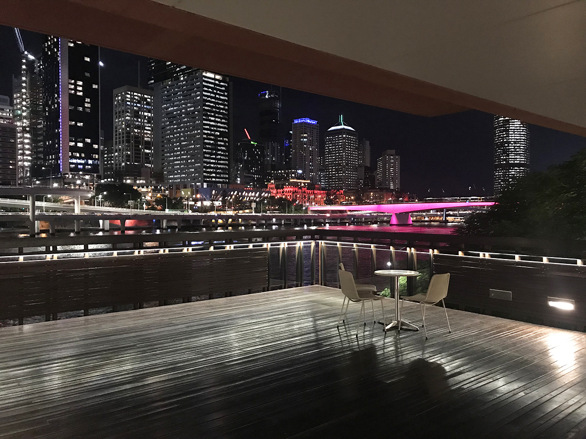 River deck overlooking the city skyline at night