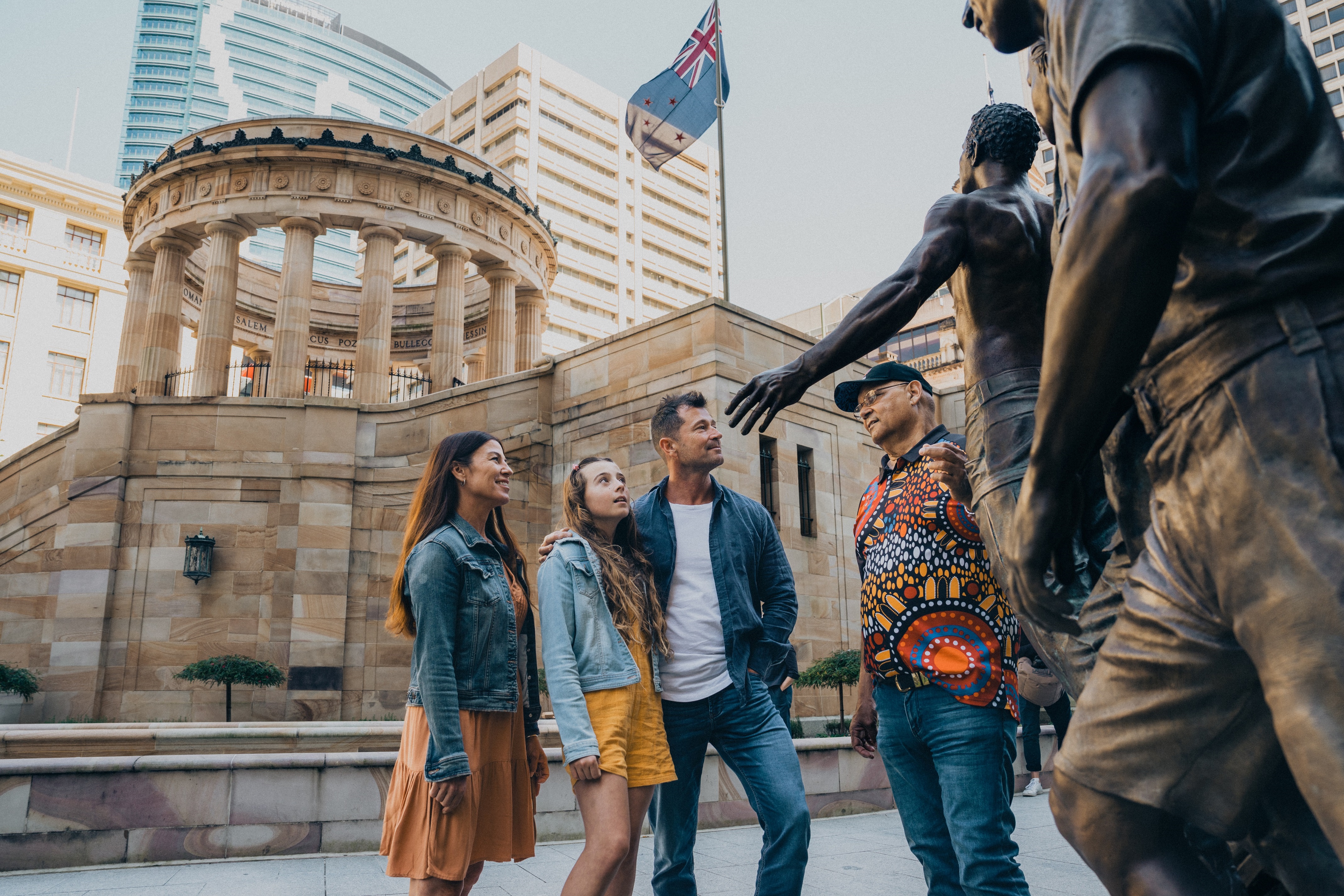 Visitors in front of a statue at Anzac Square