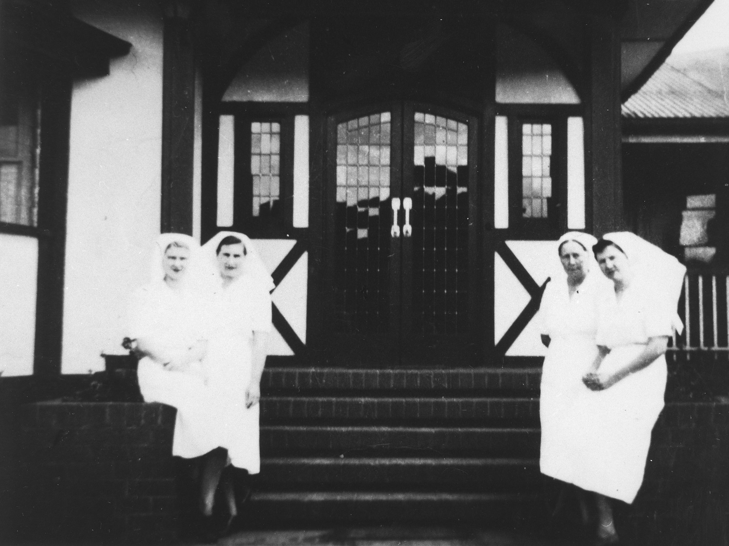 Nurses standing by the front steps outside St. Aubyn's Hospital in Kingaroy