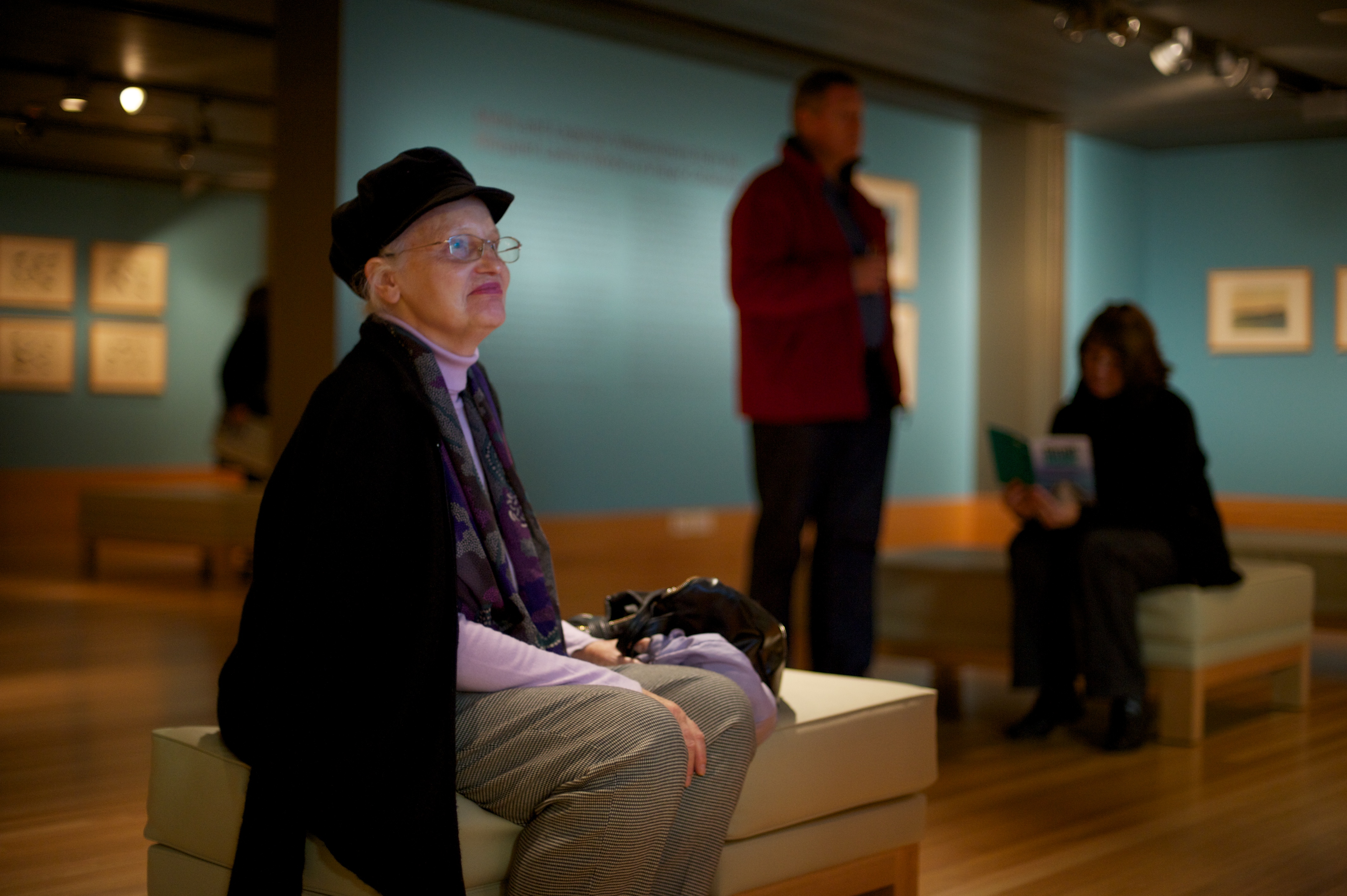 Visitor seated viewing exhibition content 