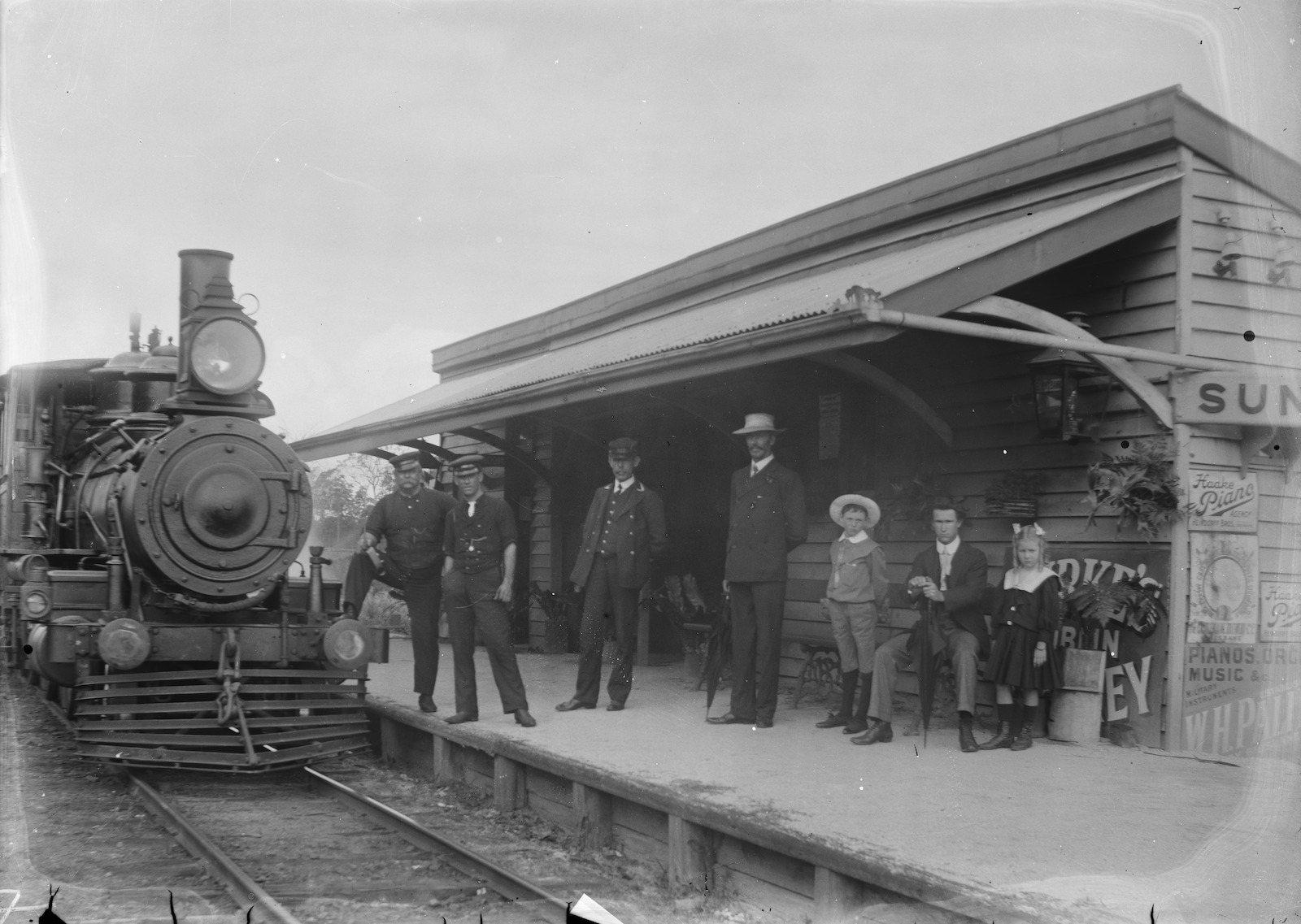 People stand on the platform at Sunnybank Station