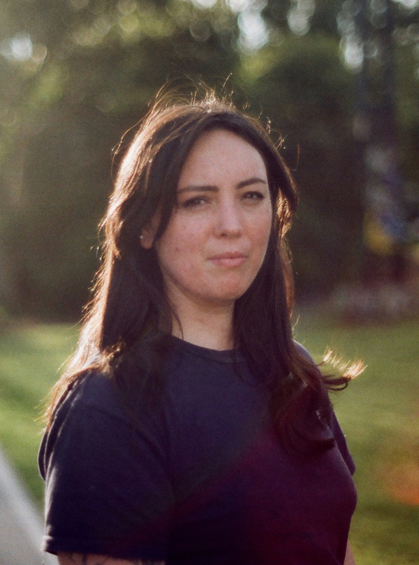 Susie Anderson with long dark hair, wearing black tshirt