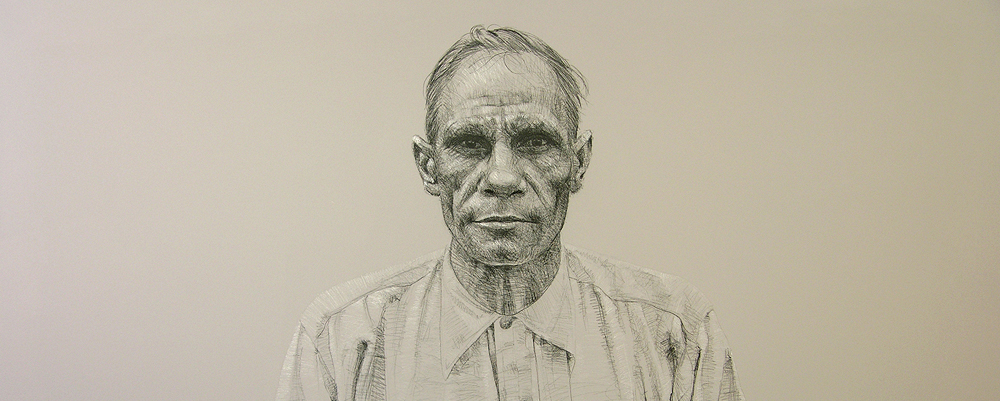 A charcoal portrait of a First Nations man wearing a button up shirt looking at the viewer