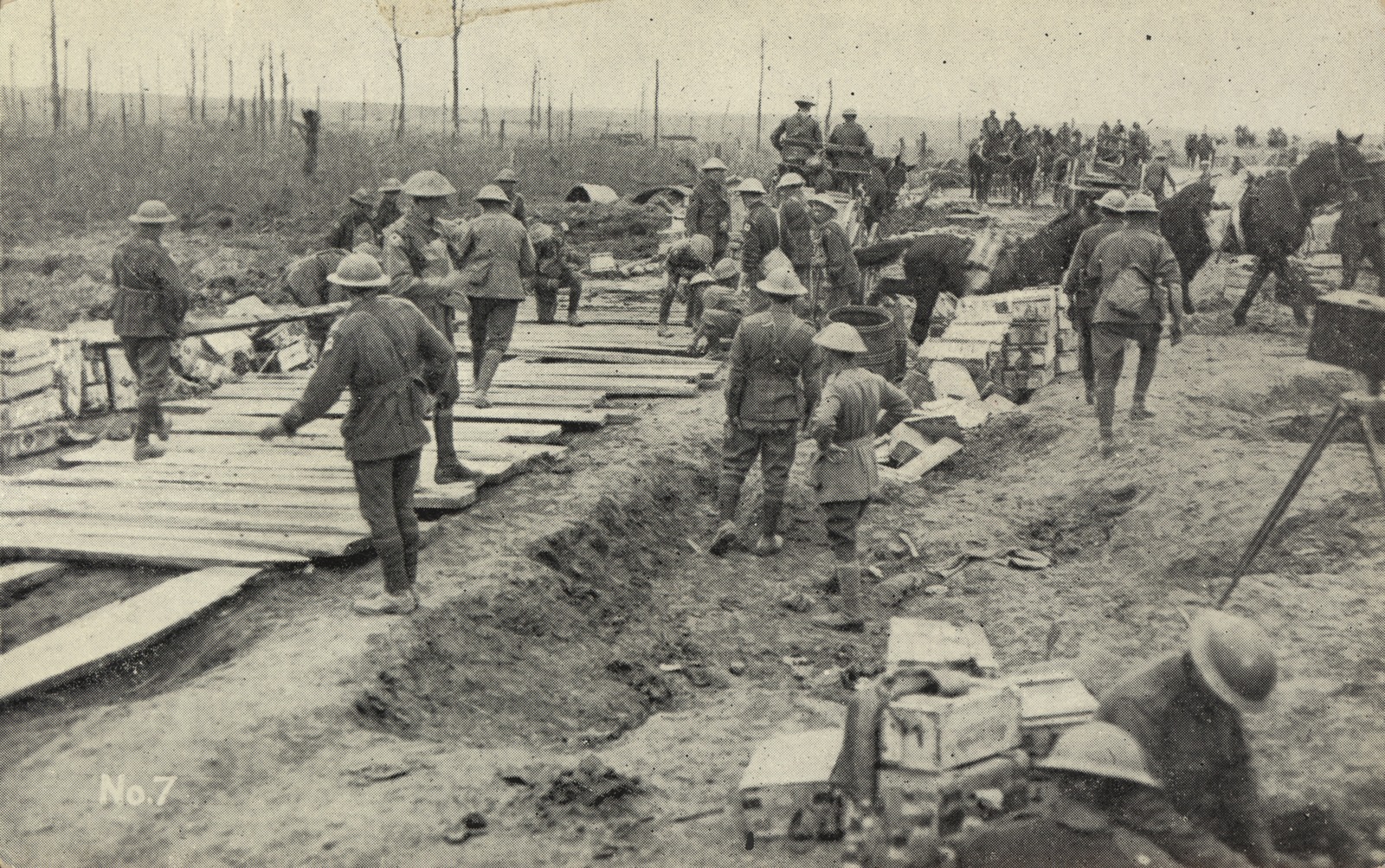Australian soldiers construct a roadway while the battle goes on, ca. 1917