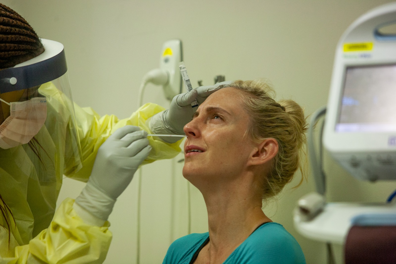Nurse Nothabo Mbambo performing a nasal swab on patient Sarah Roettgers, Princess Alexandra Hospital, Brisbane, 7 April 2020
