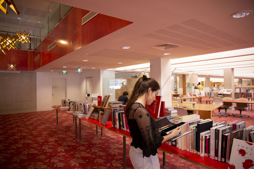 Woman reading book in library