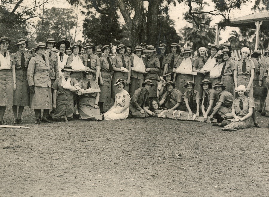 A group of women in uniform, some with their arms in slings