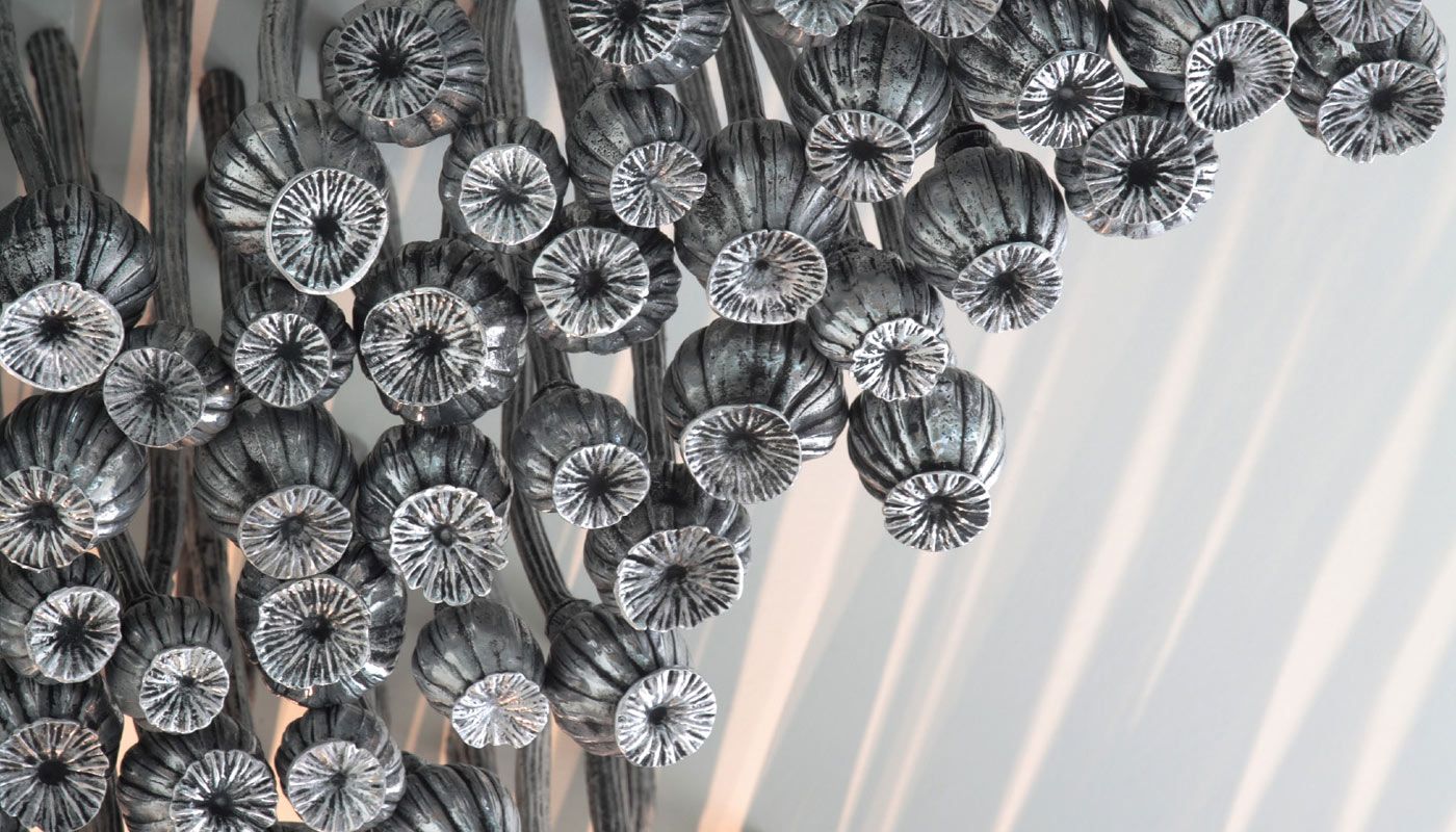 Silver metal poppy sculpture, called Black Opium by Fiona Foley