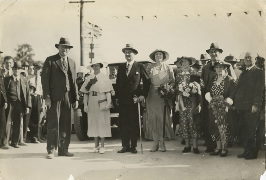 The party of dignitaries includes Manuel Hornibrook on the left and his wife, Daphne, next to him, dressed in all white. They are standing next to the Governor, Sir Leslie Orme Wilson and his wife, Lady Wilson.