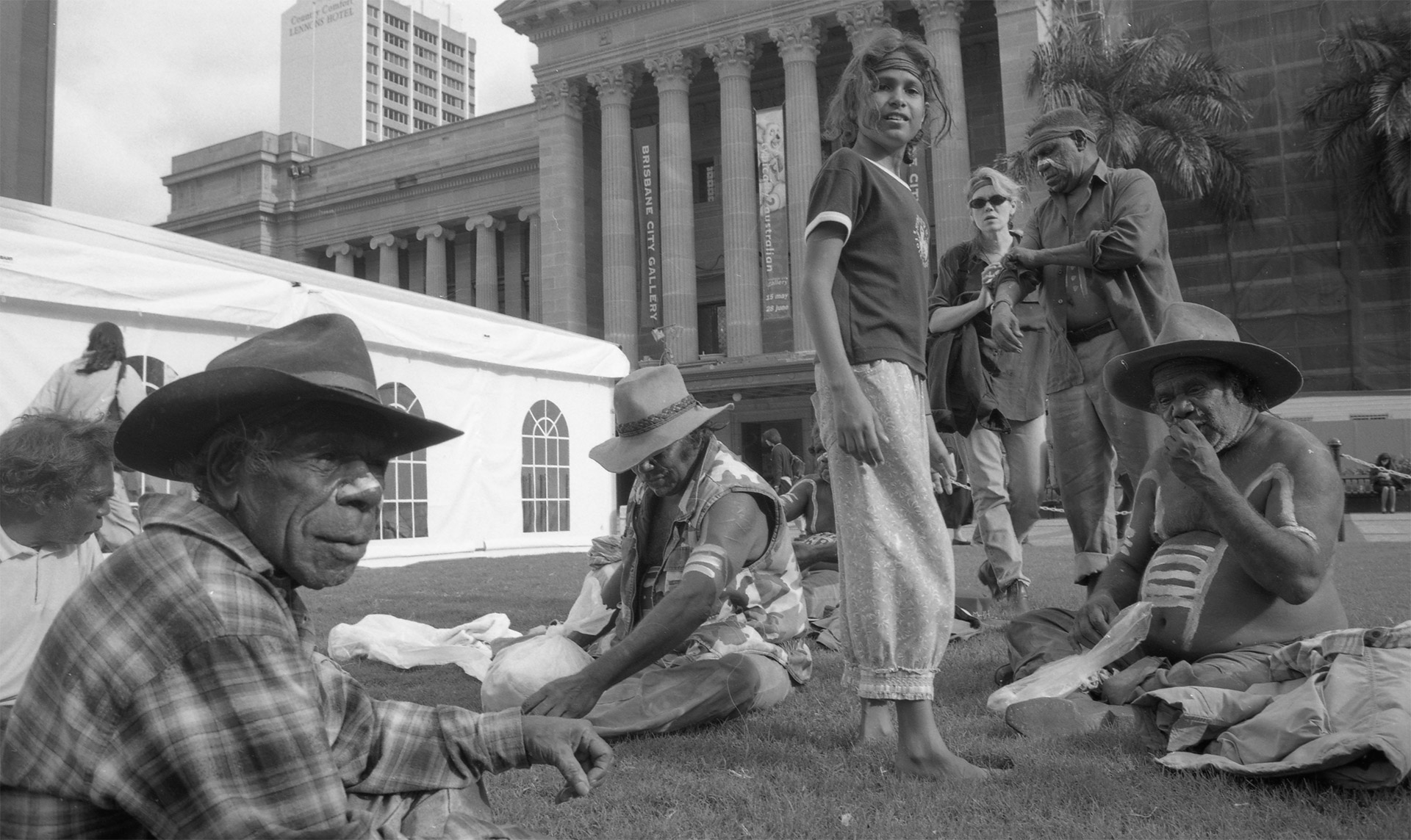 Attendees sitting on the grass at King George Square enjoying the DAR Indigenous Art and Culture Festival