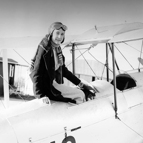 Ivy May Hassard sitting in the cockpit of an air craft, ca.1935