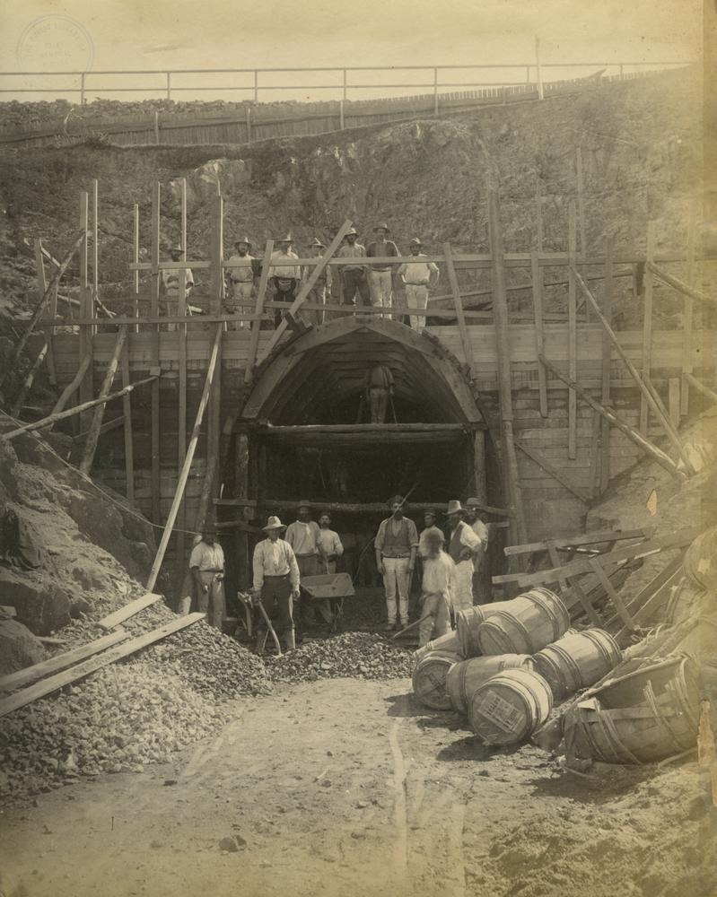 Workers standing outside the entrance to a railway tunnel under construction Brisbane ca. 1884. 