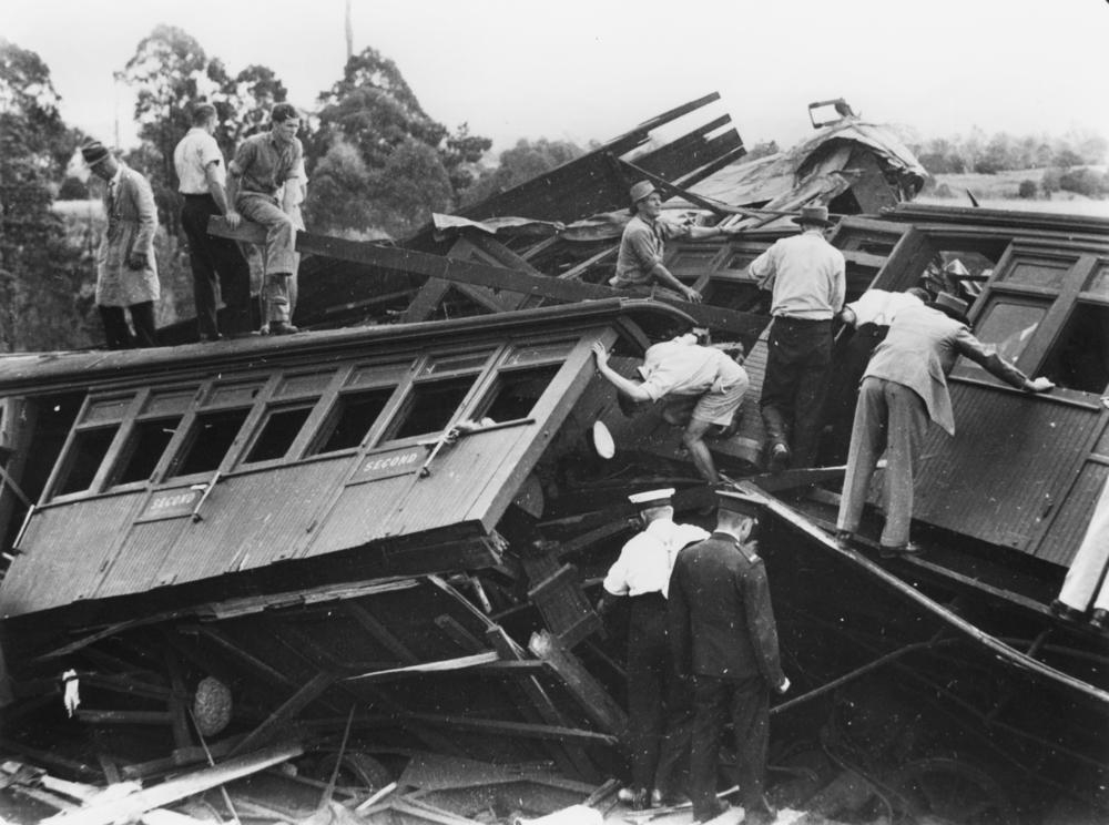 Rescuers inspect the wreckage of the Camp Mountain train disaster 1947. 