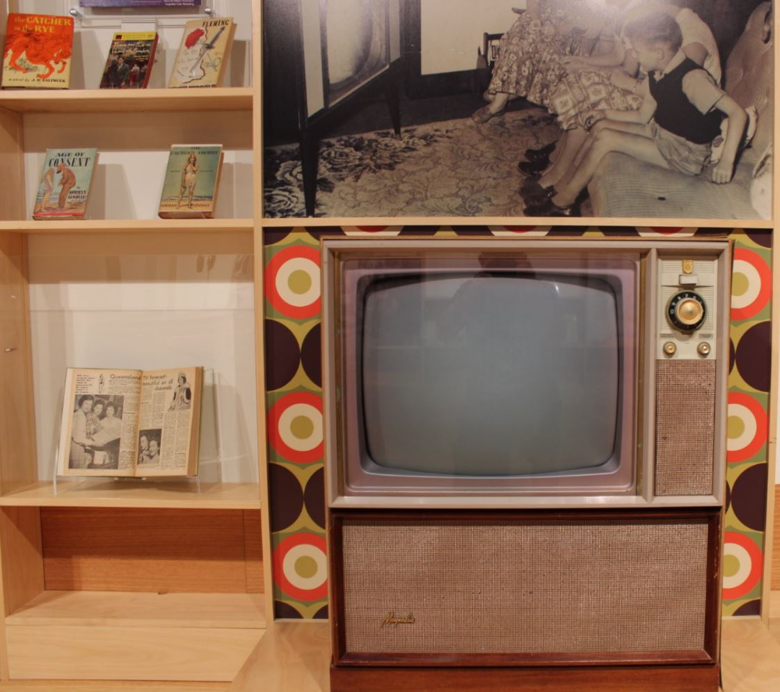 Open copy of the first edition of the TV Times (Qld edition), 1959 and a ca.1970s television set on display as part of the Freedom Then, Freedom Now exhibition in 2017