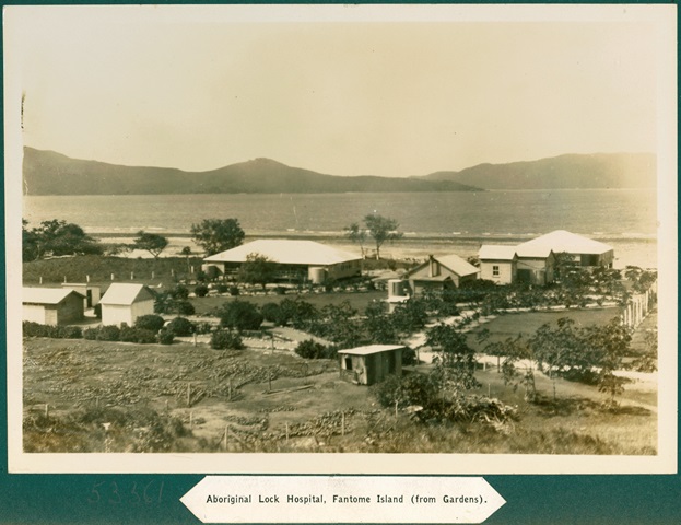 An old sepia toned image of buildings and a beach, with text reading 'Aboriginal Lock Hospital, Fantome Island (from Gardens).'