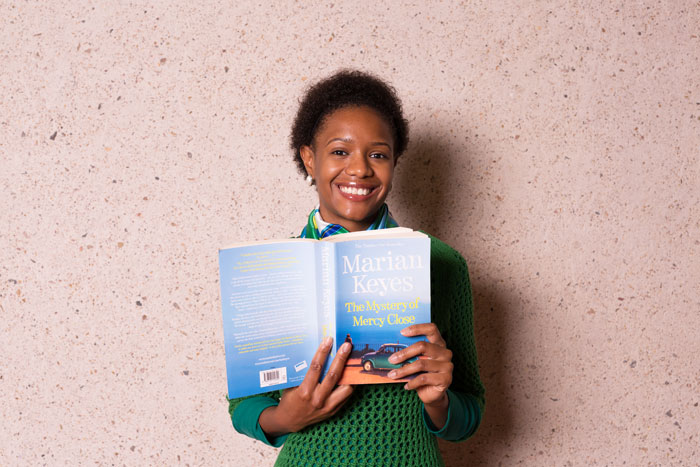 Woman holding book at the State Library. Photo by Jeff Camden.