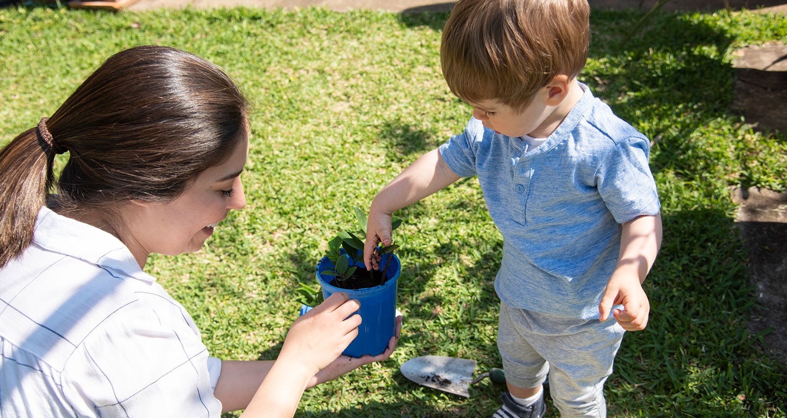 Child playing gardening with a woman