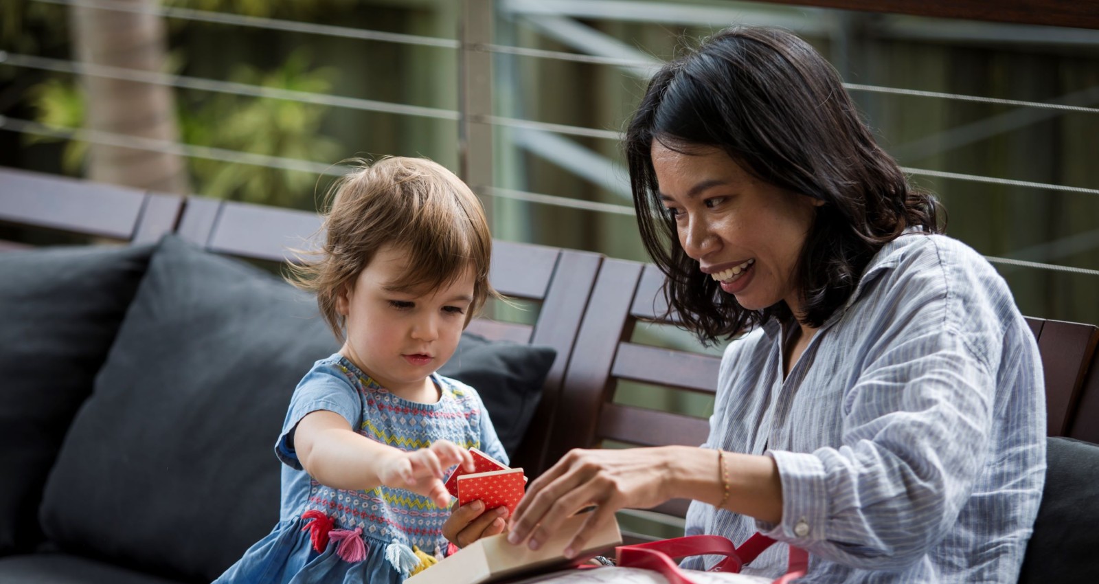 Mother and daughter looking at square tile
