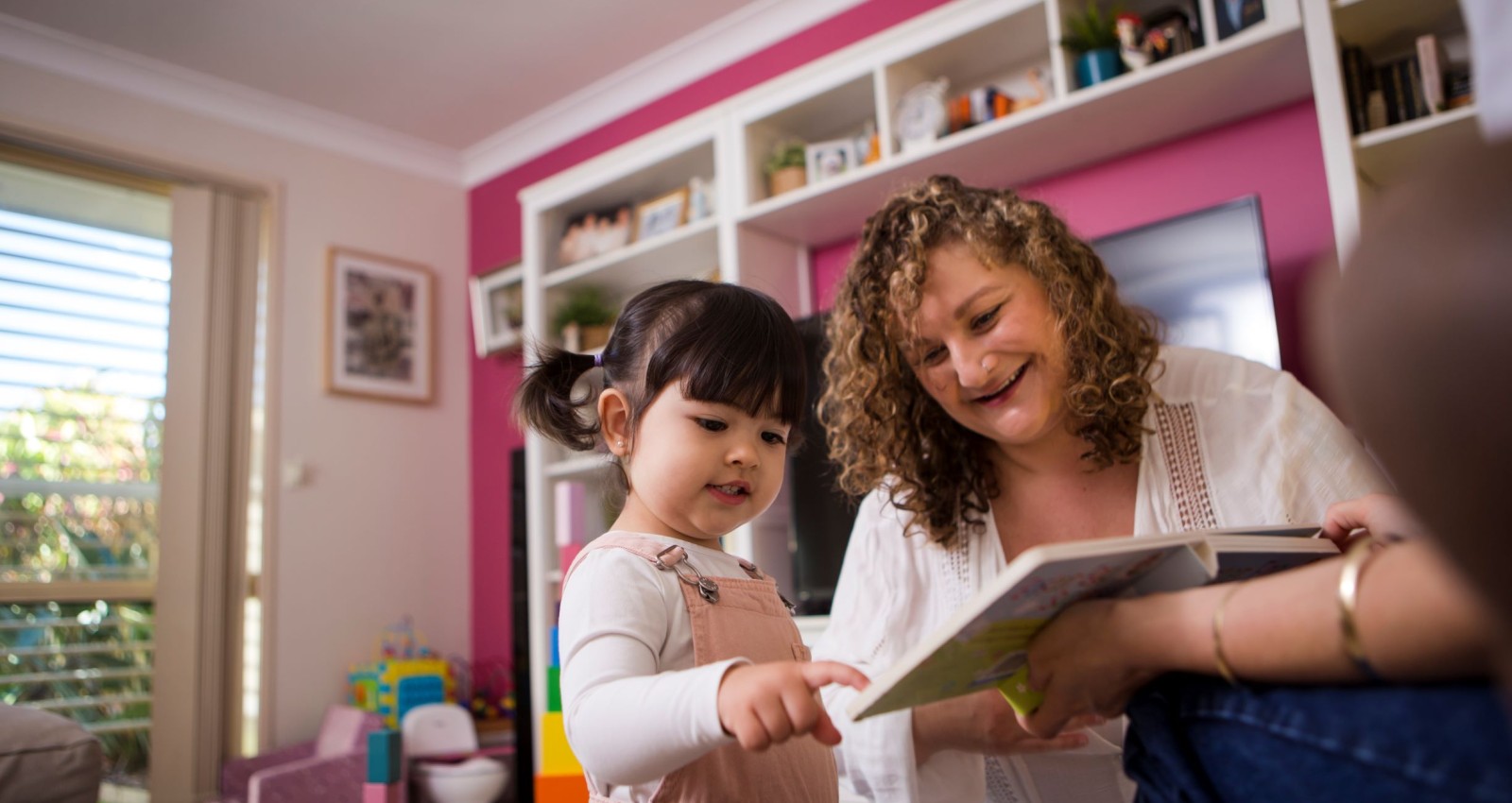 Mother and child sharing board book