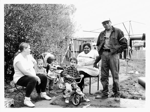 Black and white photo of Archie Roach with his family  