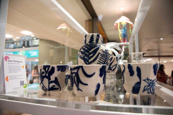 shelf of white ceramics with blue floral patterns