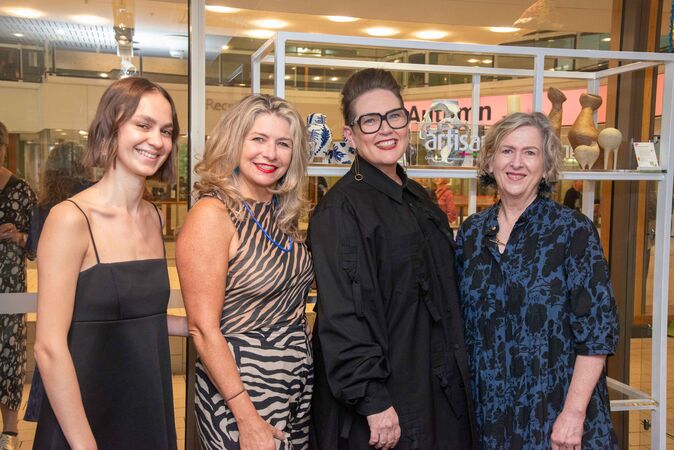 Four women in front of shop display