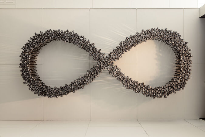 A large art installation comprising aluminium poppies arranged in a figure 8