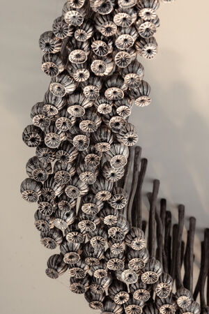 Close up detail of a large art installation comprising aluminium poppies arranged in a figure 8