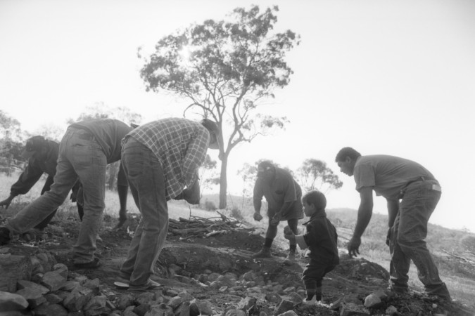 Australian South Sea Islander men preparing rocks for a hungi pit in Lakes Creek, Rockhampton, Queensland, 2000.