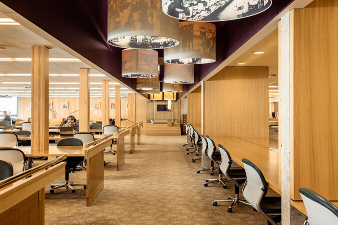 Interior of a library showing people working at desks