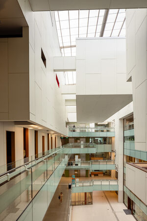 View of a a bright atrium inside a library showing balconies and people moving through the space