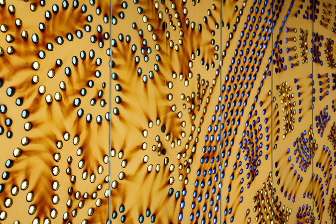 Detailed close up of "Kurilpa Country" by Lilla Watson showing bright spots on burnt brown paper